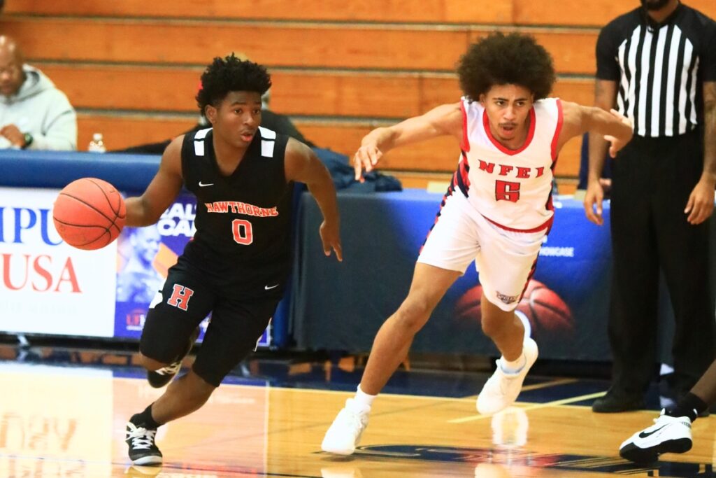 Hawthorne's Darian Bowie (0) drives to the basket against North Florida Education Institute (Jacksonville). Photo by C.J. Gish