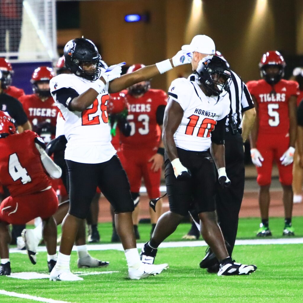 Hawthorne's Dracen Martin (26) and Kyle Ingram (10) with a tackle for a loss against Blountstown in the FHSAA Rural State Championship game. Photo by C.J. Gish