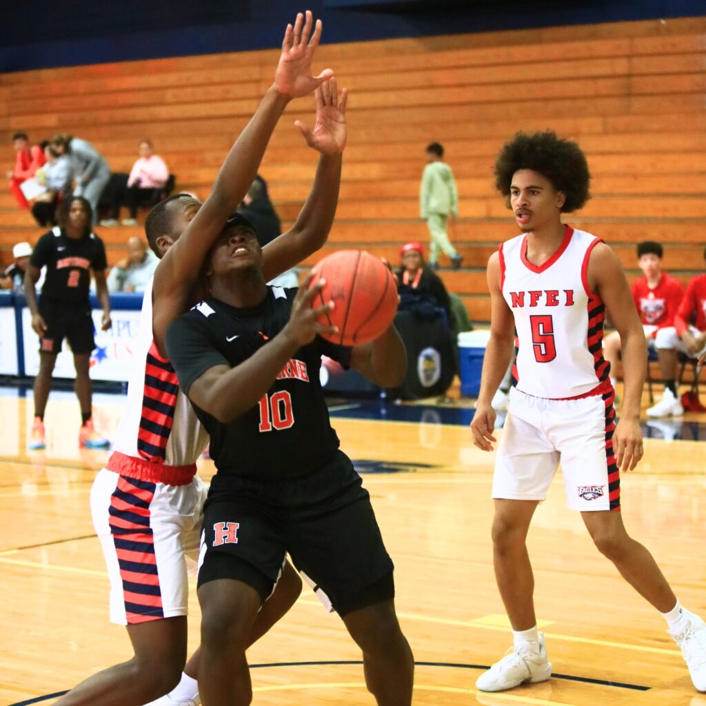 Hawthorne's Kyler Ingram (10) goes up for a basket against North Florida Education Institute (Jacksonville). Photo by C.J. Gish