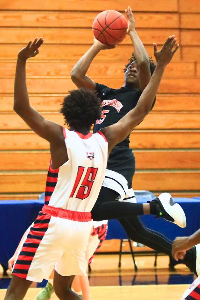 Hawthorne's Leveon Harris (15) puts up a shot against North Florida Education Institute (Jacksonville). Photo by C.J. Gish
