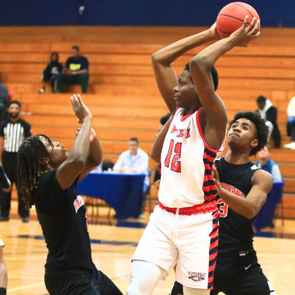 Hawthorne's Nathan Jennings (2) and Dominick Harvey (3) surround a North Florida Education Institute (Jacksonville) player. Photo by C.J. Gish