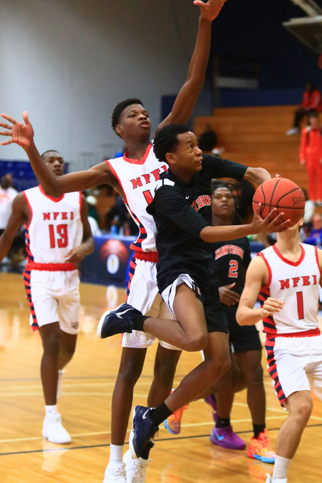 Hawthorne's Shaun Bowie (1) drives to the basket against North Florida Education Institute (Jacksonville).