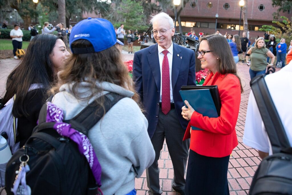 Interim UF President Donald Landry chats with event attendees before the lighting ceremony. Photo by Megan V. Winslow