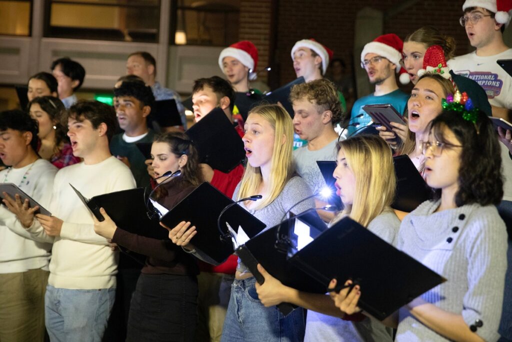 Members of the UF Concert Choir sing holiday carols. Photo by Megan V. Winslow