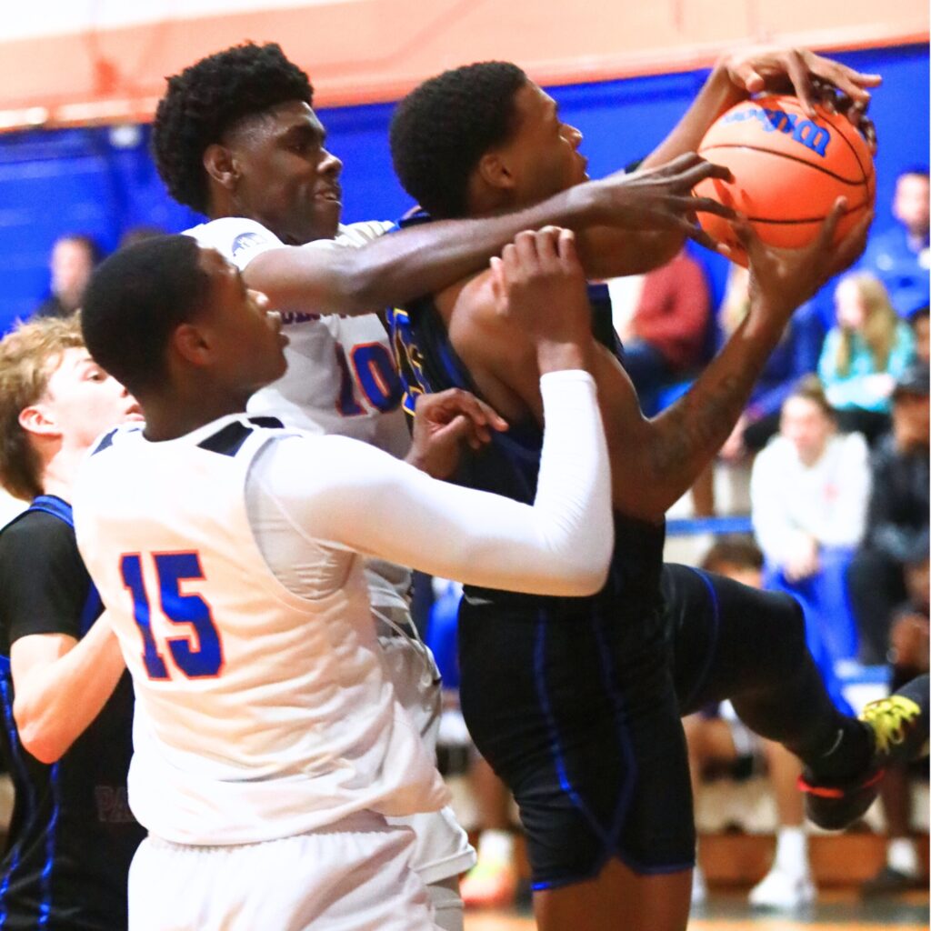 Newberry's Brandon Kelly (15) battles for a rebounds against P.K. Yonge's Eugene Hall (10) and Tray’Sean Jones (15). Photo by C.J. Gish