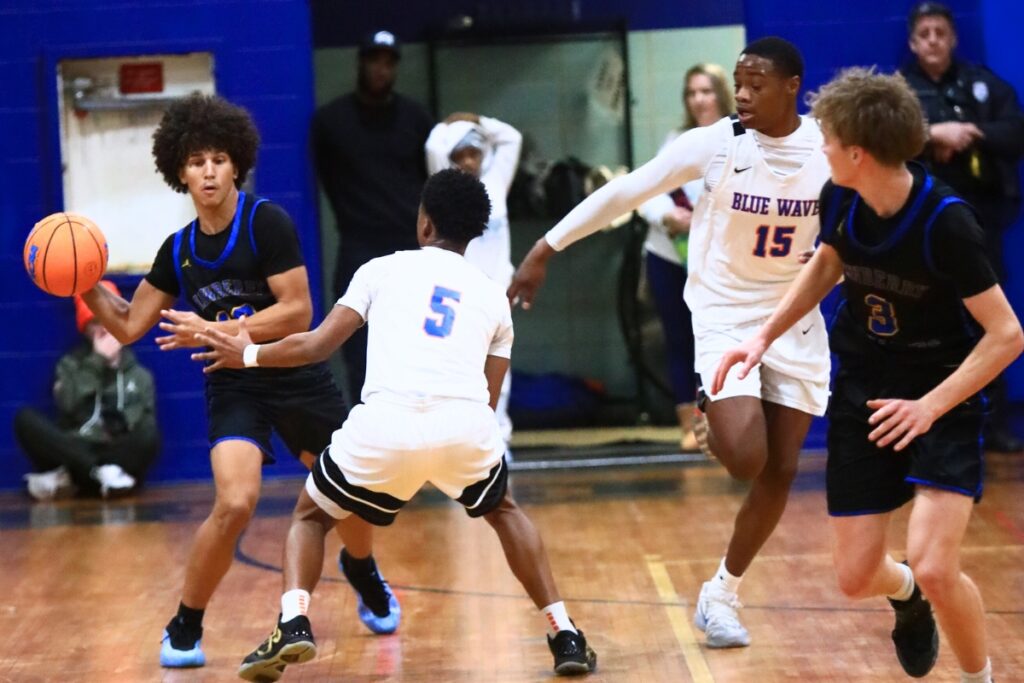 Newberry's Kai Washington (13) passes to Henry Mathias (3) in transition against P.K. Yonge. Photo by C.J. Gish