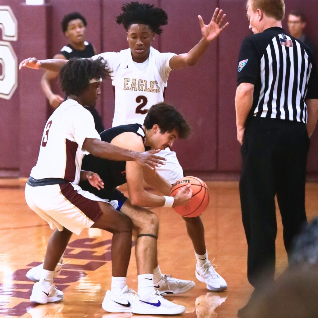 Oak Hall's Amari Ray (3) and Correy Brooks Jr. (2) trap P.K. Yonge's Collin Meyer (1). Photo by C.J. Gish