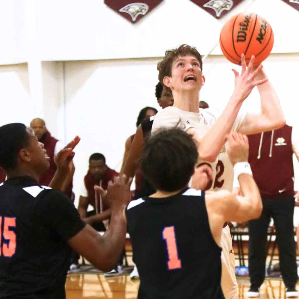 Oak Hall's Elijah Medved (32) puts up a shot against P.K. Yonge's Tray’Sean Jones (15) and Collin Meyer (1). Photo by C.J. Gish