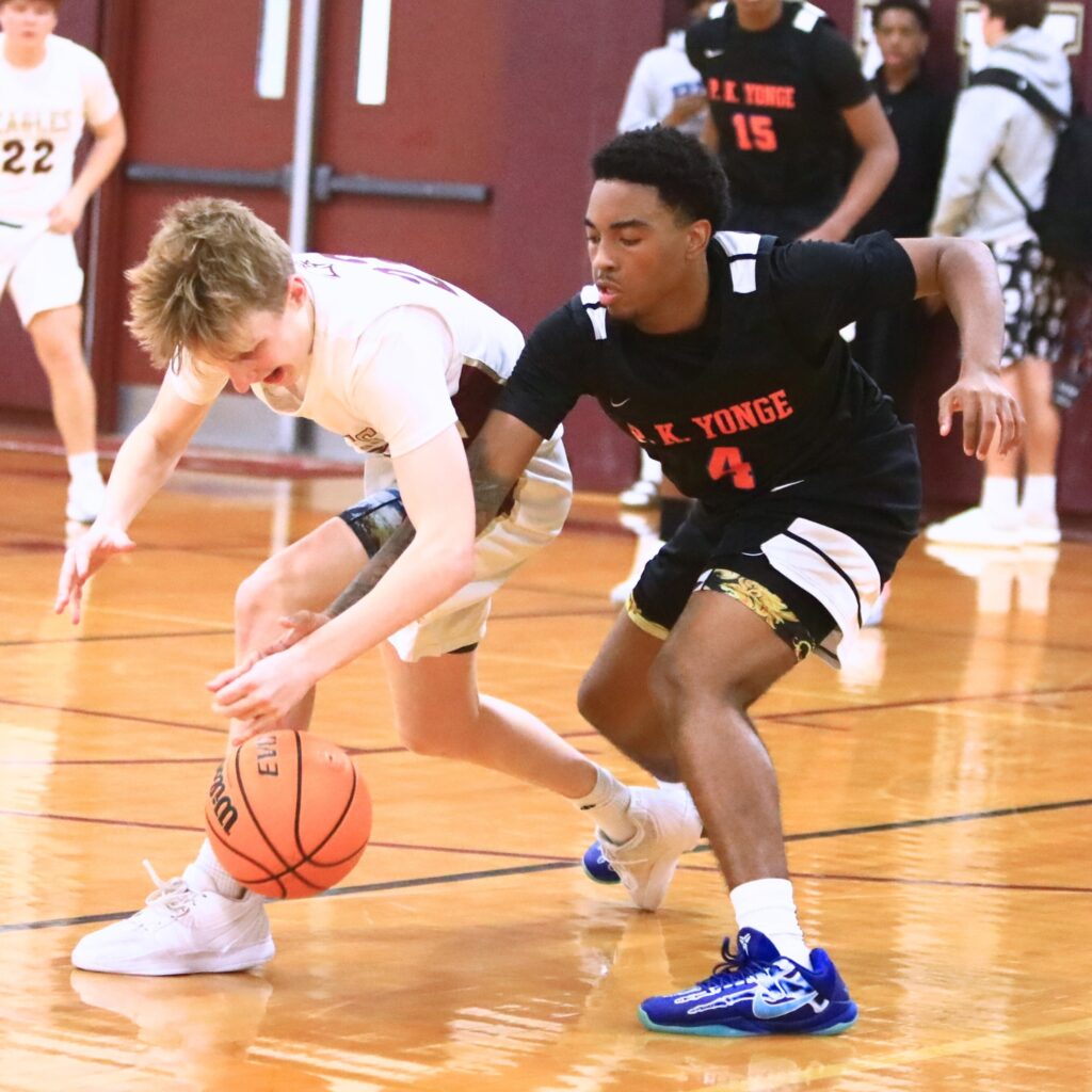 Oak Hall's Max Whitmer (23) and P.K. Yonge's Decedric Sowell (4) battle for the ball. Photo by C.J. Gish