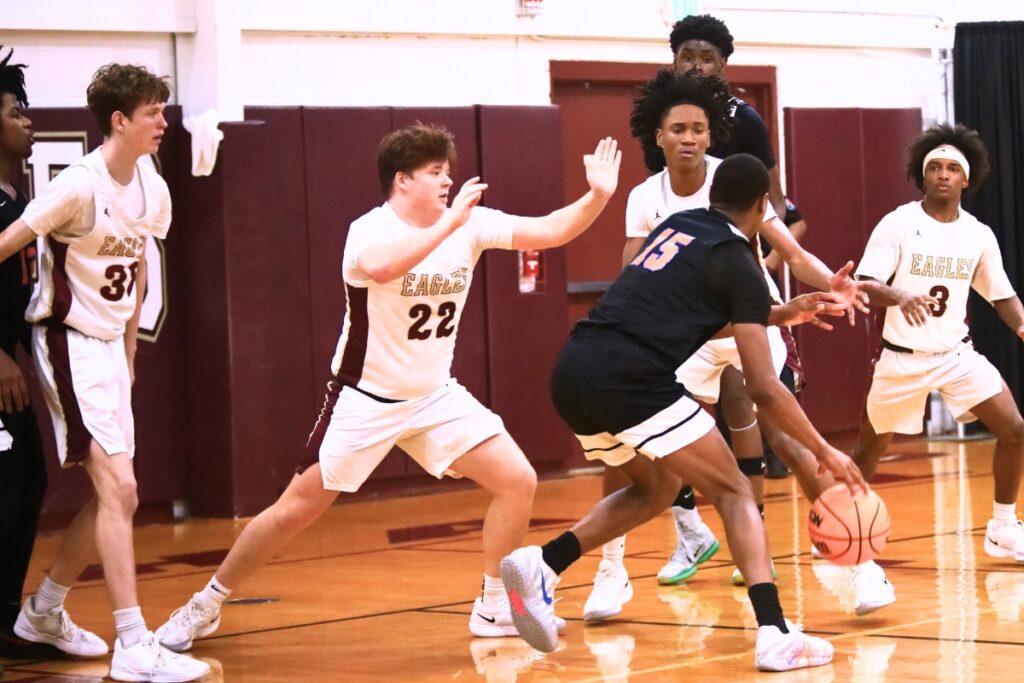 P.K. Yonge's Tray’Sean Jones (15) looks to pass after being surrounded by Oak Hall's defense.