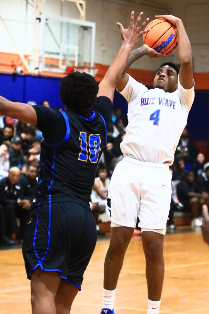 P.K. Yonge's Decedric Sowell (4) shoots the ball against Newberry's Darius Debose (10). Photo by C.J. Gish