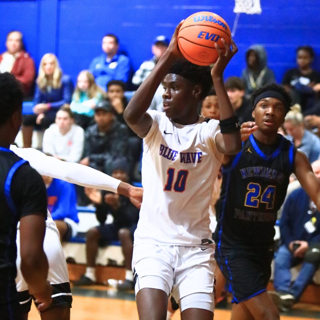 P.K. Yonge's Eugene Hall (10) grabs a rebound against Newberry. Photo by C.J. Gish