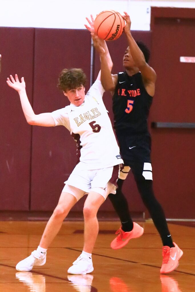 P.K. Yonge's Jayden Harriott (5) tries to pass against Oak Hall's Cash Roth (5). Photo by C.J. Gish