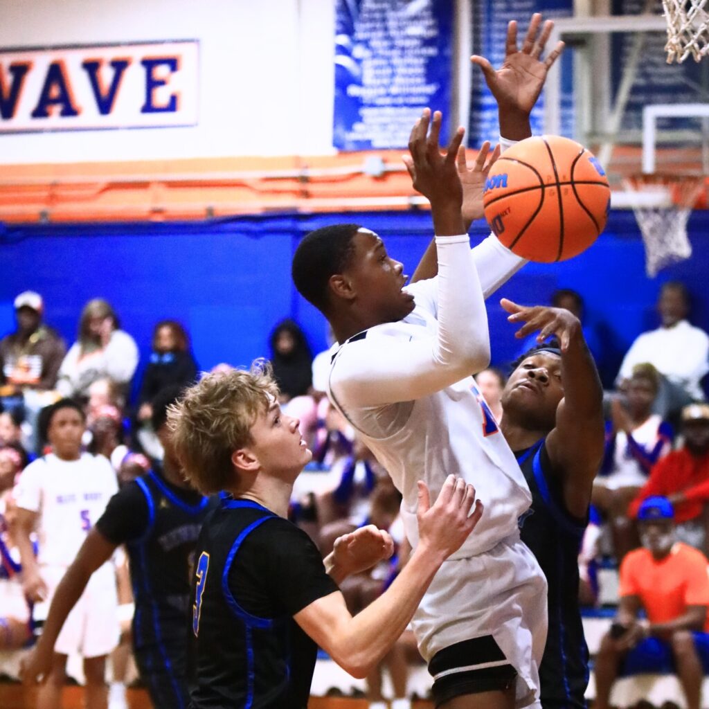 P.K. Yonge's Tray’Sean Jones (15) is defended by Newberry's Juwan Scippio (24) and Henry Mathias (3). Photo by C.J. Gish
