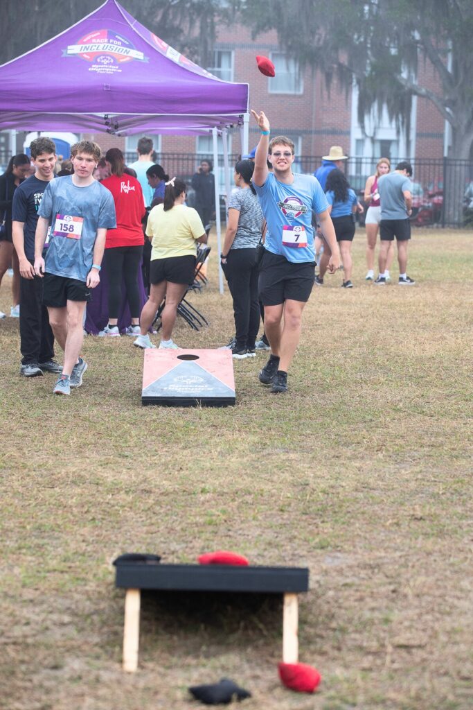 Students unwind with a game of corn hole before the race.