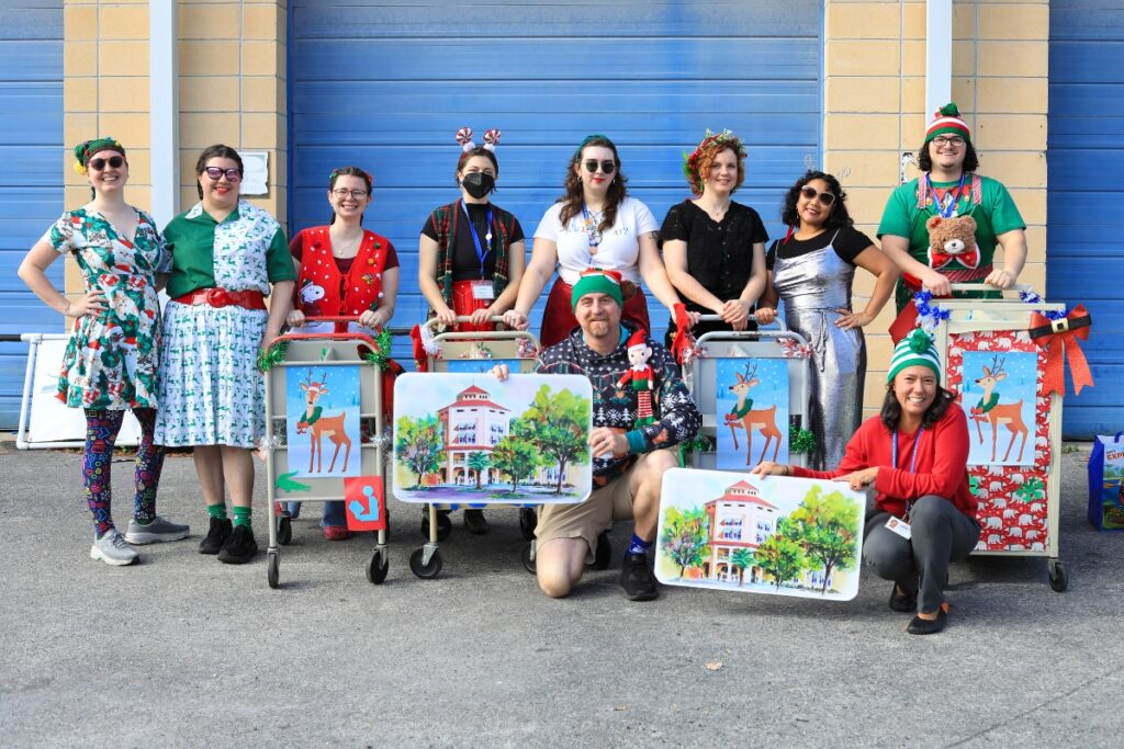 The Alachua County Libraray District readies to march in A Very GNV Holiday Parade with giant library cards and book carts. Photo by Seth Johnson