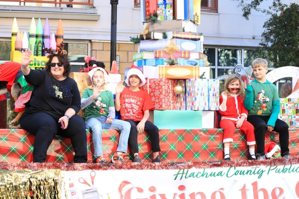 The Alachua County Public Schools float travels through downtown Gainesville. Photo by Seth Johnson