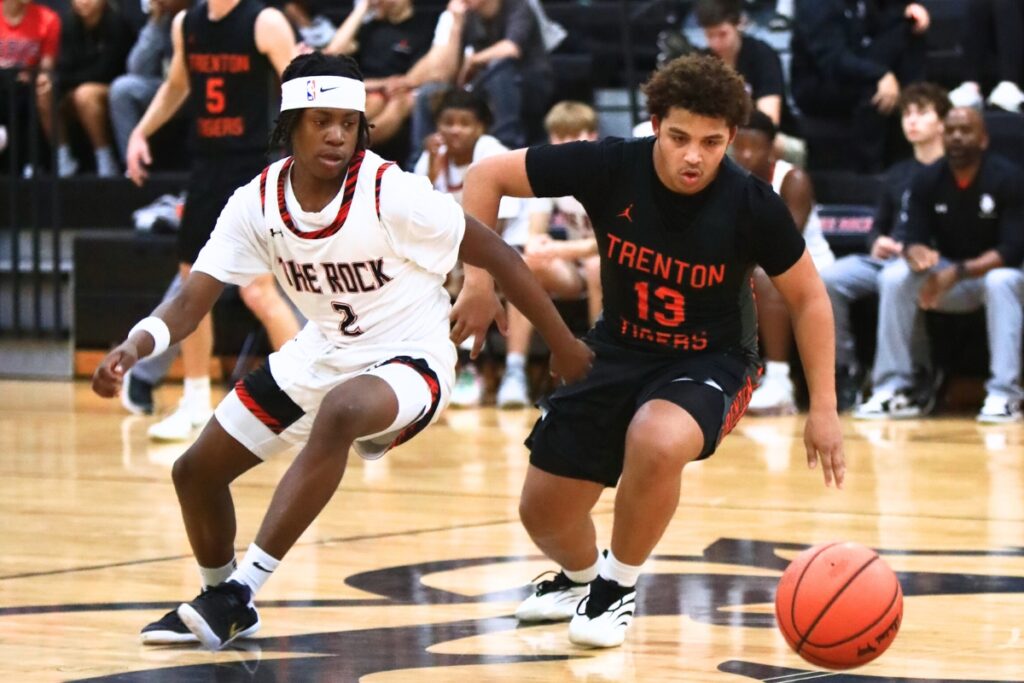 The Rock's Kyroe Jordan (2) and Trenton's BB Ford (13) go after a loose ball. Photo by C.J. Gish