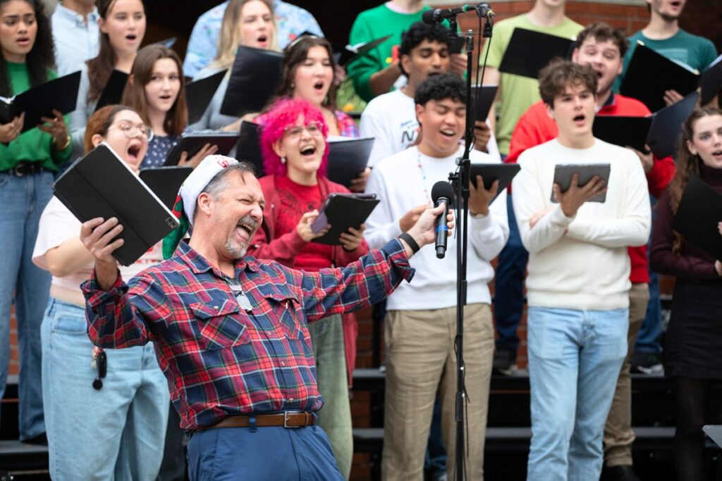 Travis Kern, a doctoral candidate in choral conducting, leads the UF Concert Choir in a performance of You’re a Mean One, Mr. Grinch.”