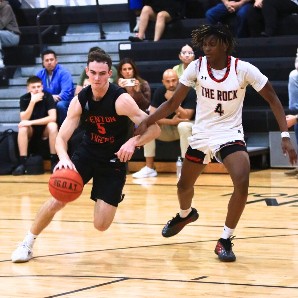 Trenton's Mason VunCannon (5) drives to the basket against The Rock's Marco Johnson (4). Photo by C.J. Gish 1