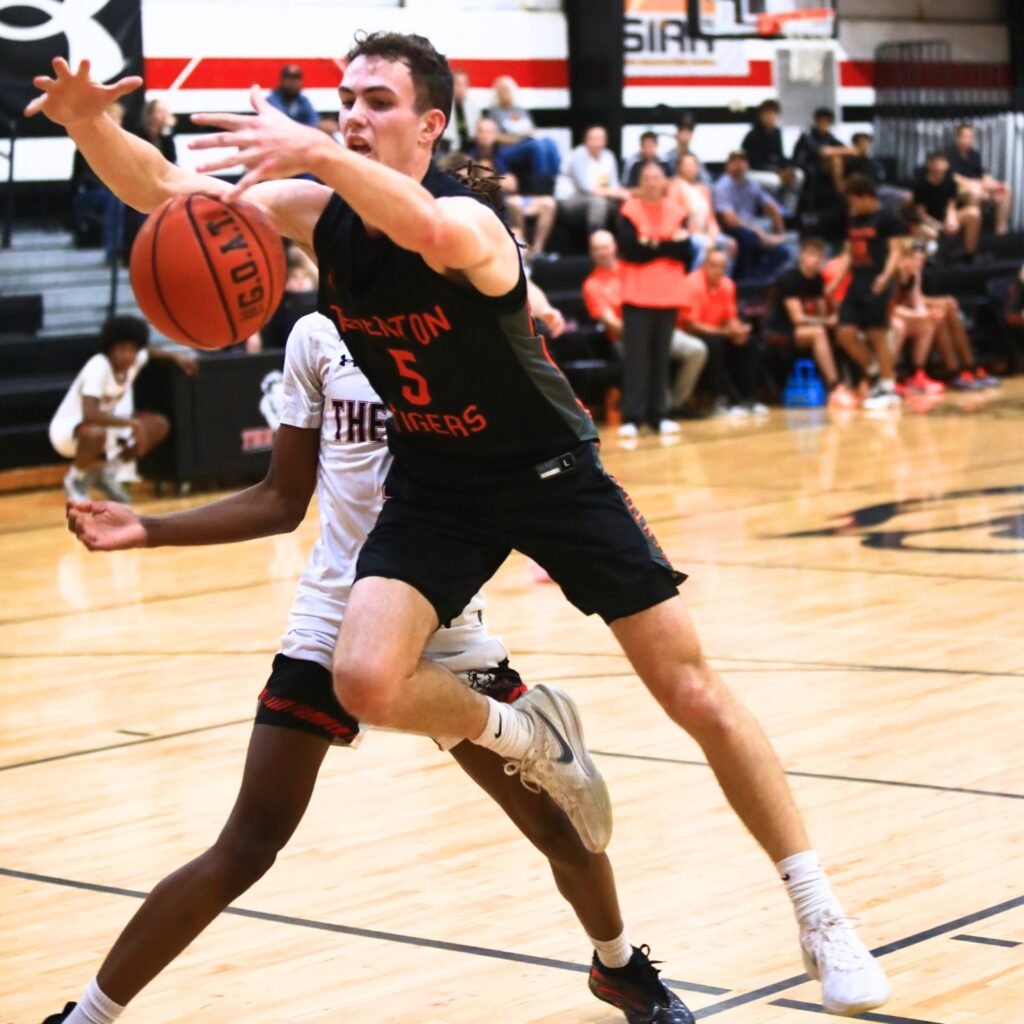 Trenton's Mason VunCannon (5) goes after a loose ball against The Rock. Photo by C.J. Gish 1