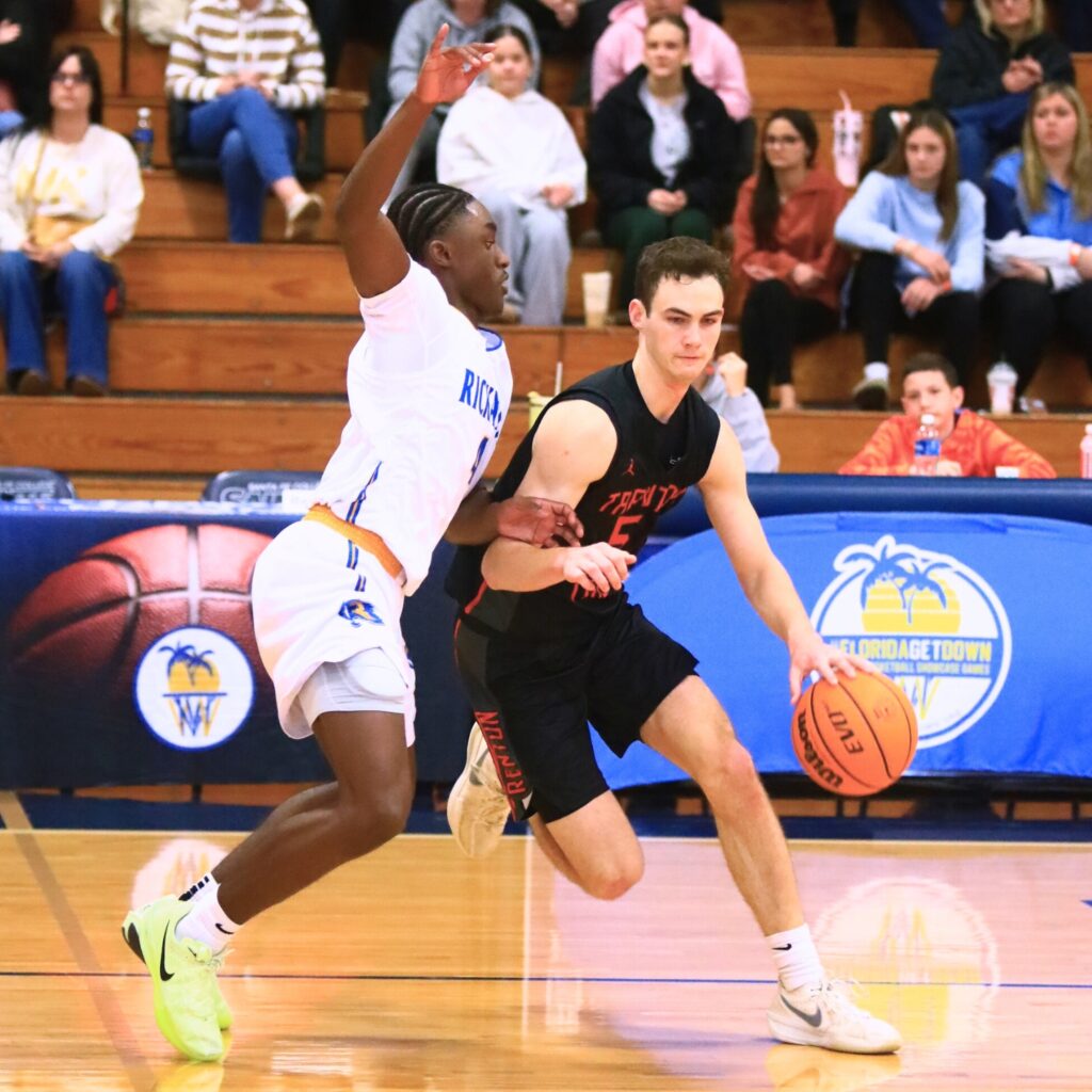 Trenton's Mason VunCannon (5) tries to go around a Rickards (Tallahassee) player. Photo by C.J. Gish