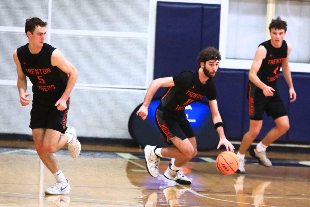 Trenton's Nathan Ridgell (11) pushes the ball down the court against Rickards (Tallahassee) on Tuesday. Photo by C.J. Gish