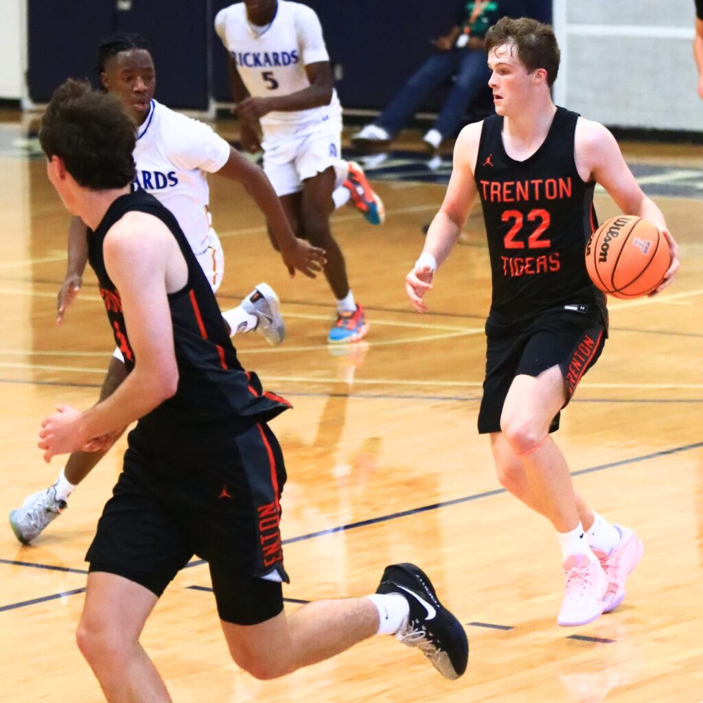 Trenton's Tyler Bullis (22) dribbles down the court againt Rickards (Tallahassee). Photo by C.J. Gish
