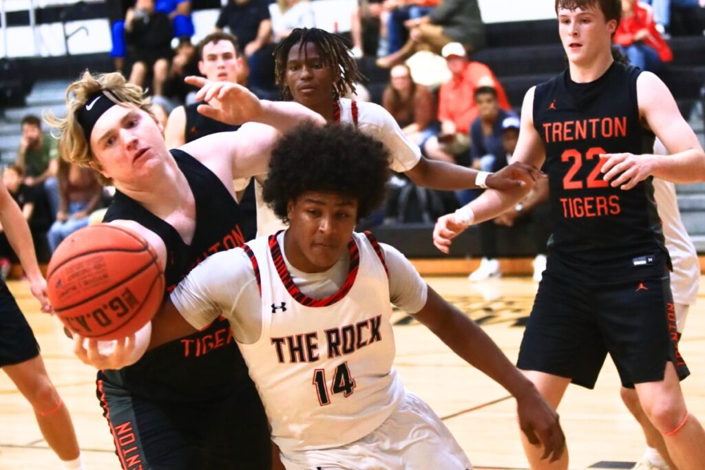 Trenton's Zaiden Bon (32) and The Rock's Deondre Alford (14) go after a loose ball. Photo by C.J. Gish