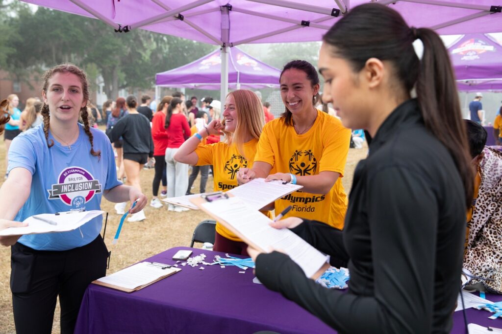 Volunteers hand out waivers to race participants.