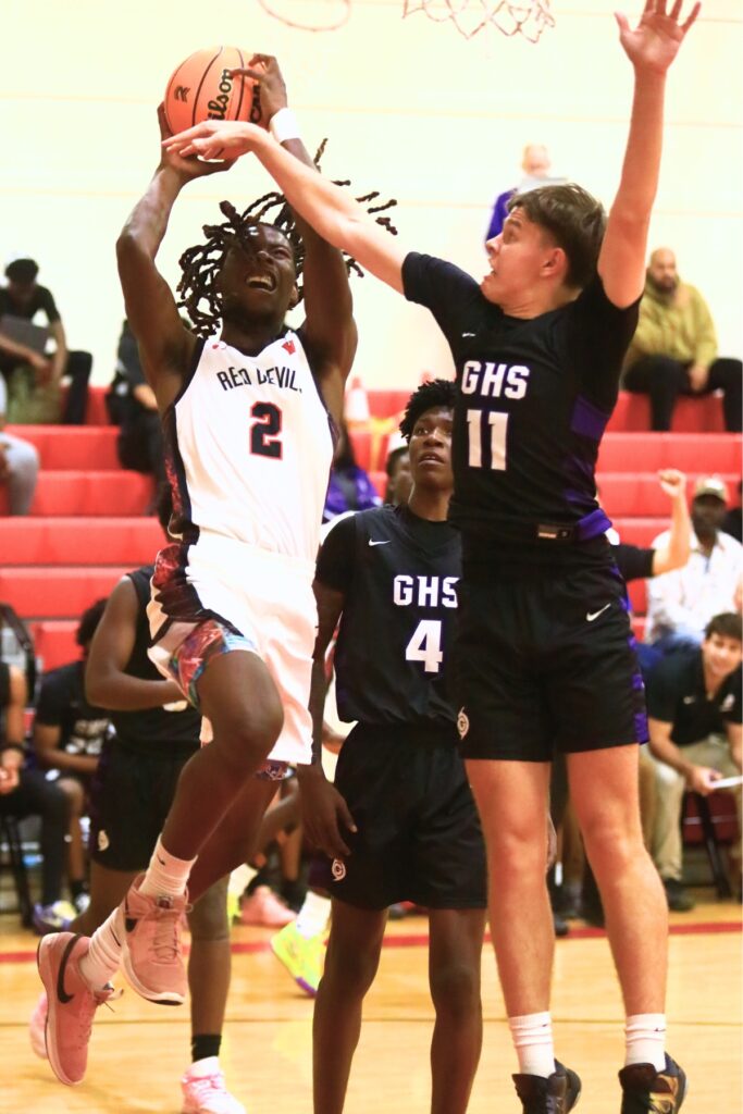 Williston's Jaden Magee (2) goes for a shot against Gainesville's Kyle Pinter (11). Photo by C.J. Gish