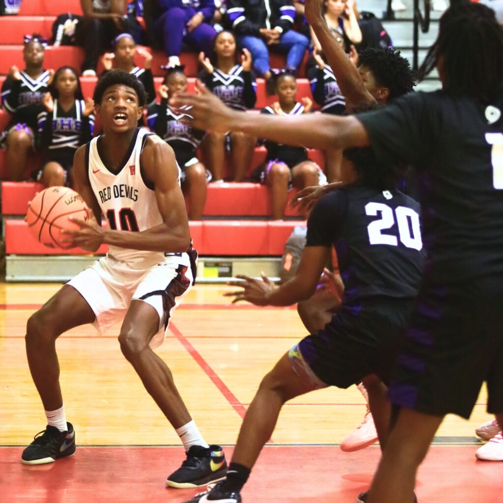 Williston's Malichi Fernandez (10) looks to put up a shot against Gainesville. Photo by C.J. Gish