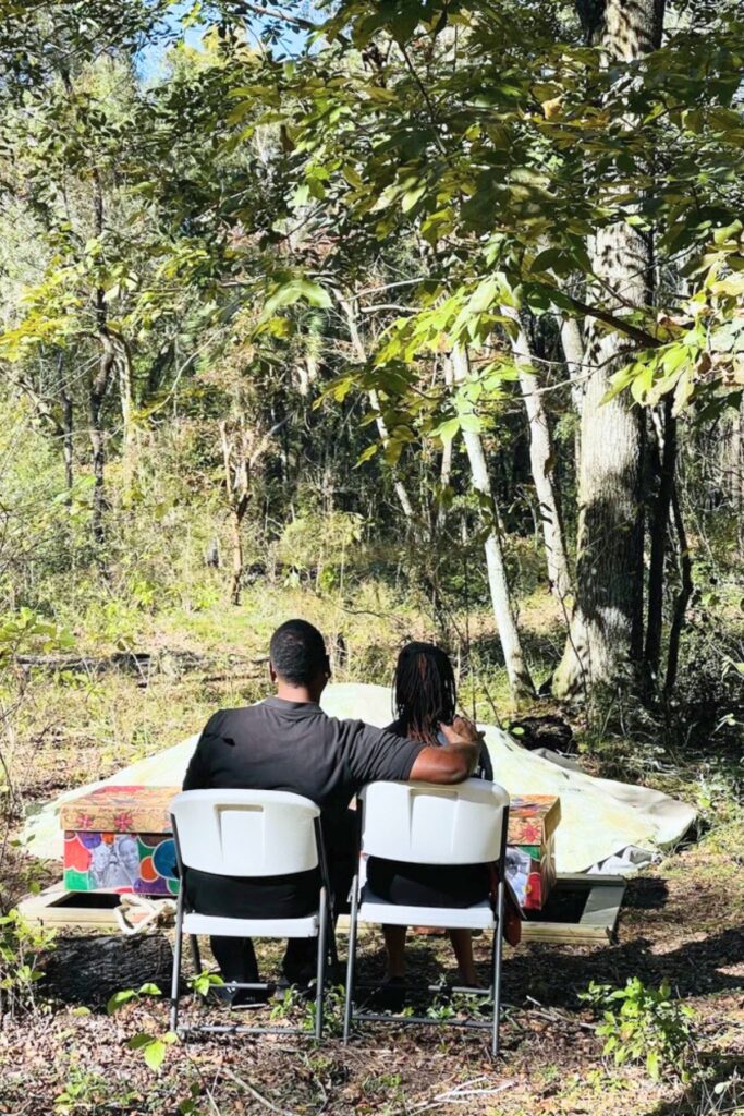 A family sits graveside at Prairie Creek Conservation Cemetery. Prairie Creek Conservation Cemetery Courtesy of Prairie Creek Conservation Cemetery
