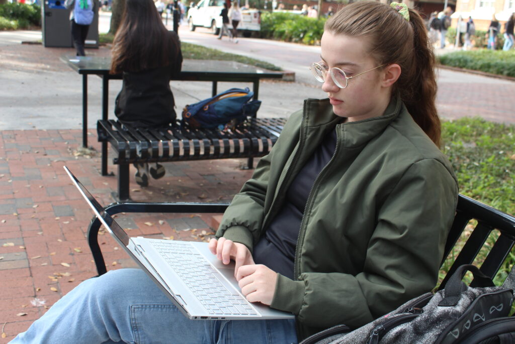 Aleigha Morris, a UF animal science and microbiology junior, works on her laptop on Monday morning. Photo by Nick Anschultz