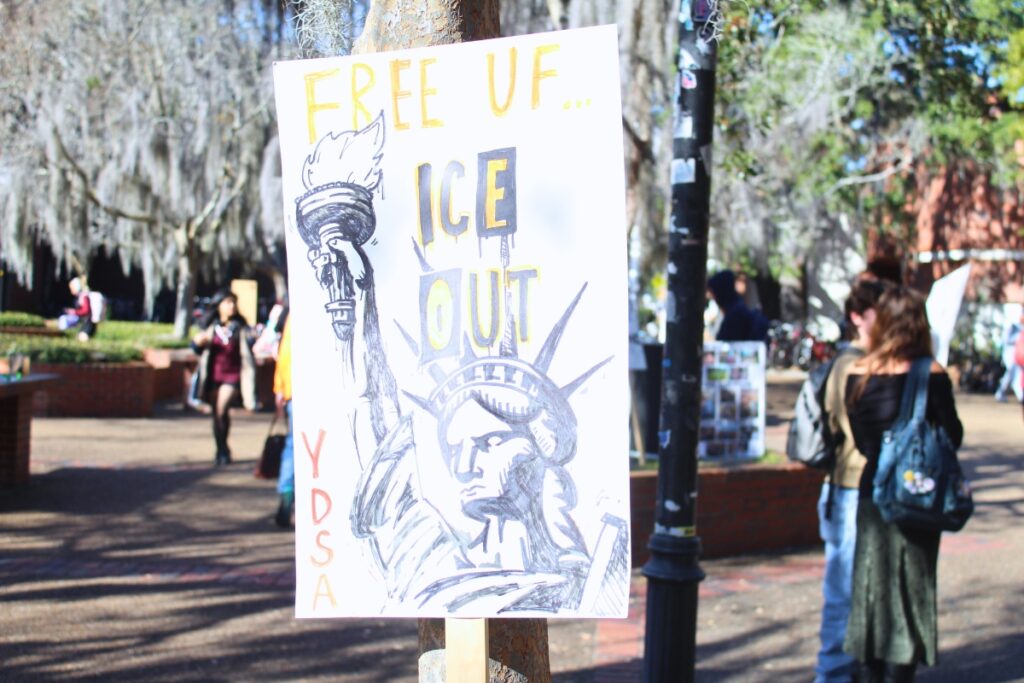 An anti-ICE sign sits against a tree in Turlington Plaza on Friday. Photo by Nick Anschultz