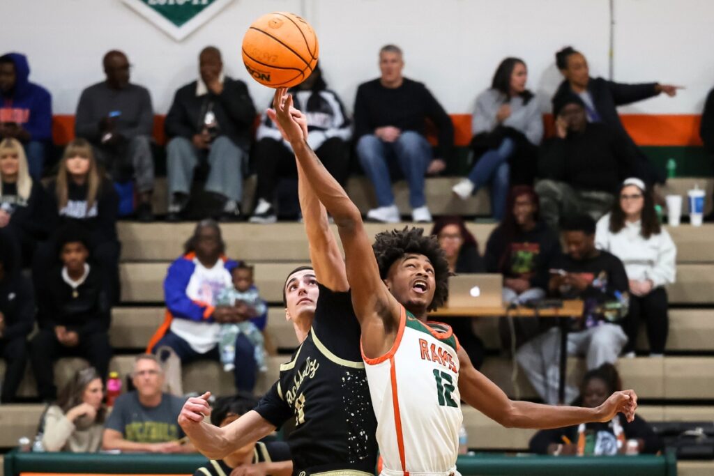 Buchholz's Gabe Williams (21) and Eastside Jaivion Williams (12) jump for the opening tipoff. Photo by Chris Watkins