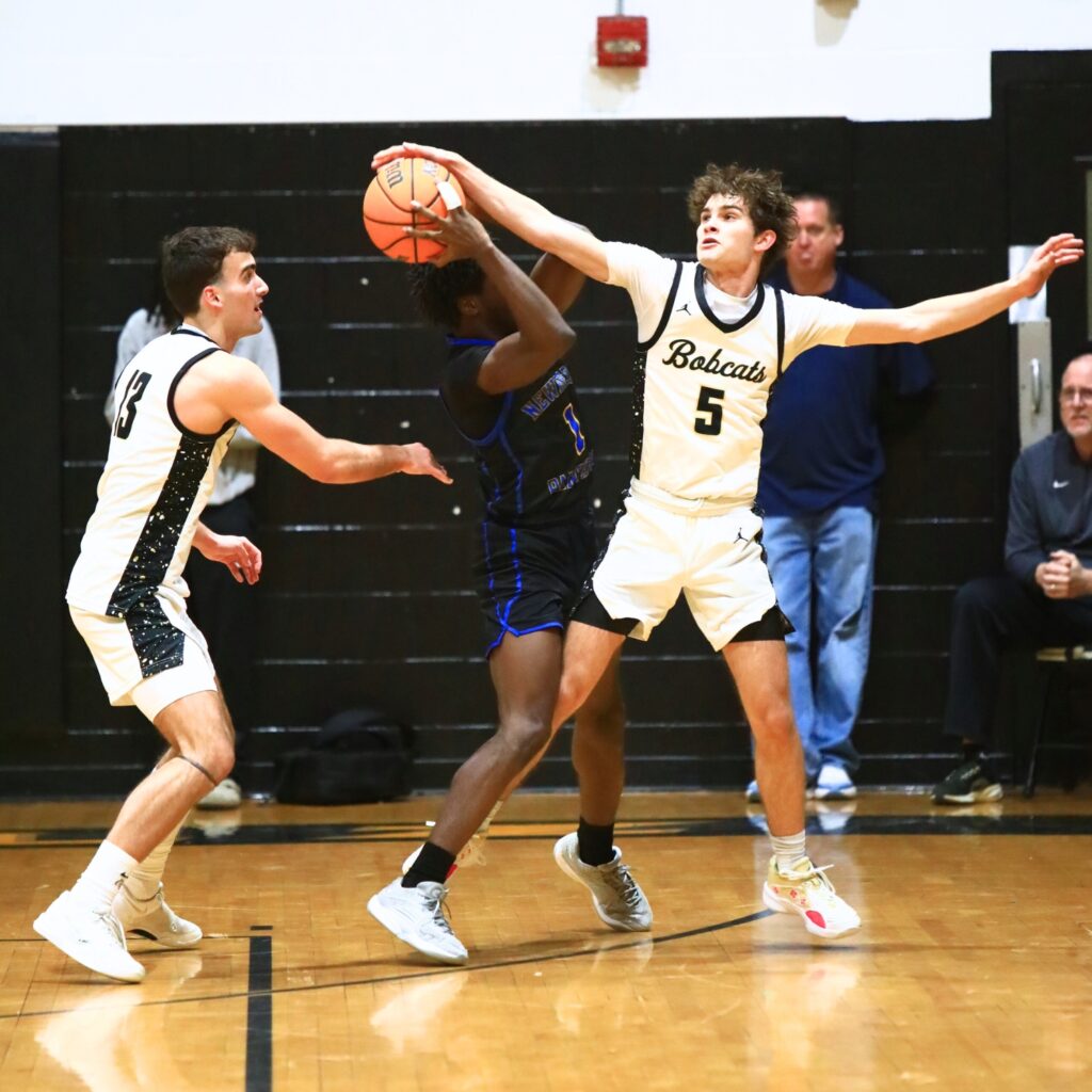 Buchholz's Lucas Bhatia (5) goes after the ball against Newberry's Quantez Robinson (1). Photo by C.J. Gish
