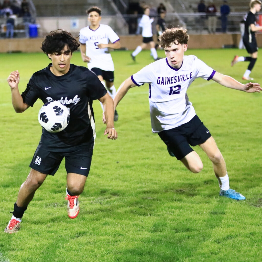 Buchholz's Sebastian Jemenez (18) and Gainesville's Jacob Eagle (12) go after the ball. Photo by C.J. Gish