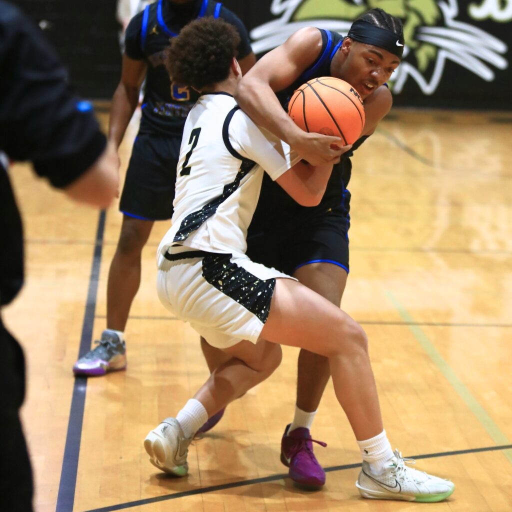 Buchholz's Tayshawn Jordan (2) forces a jump ball with Newbery's Darius Debose (10).