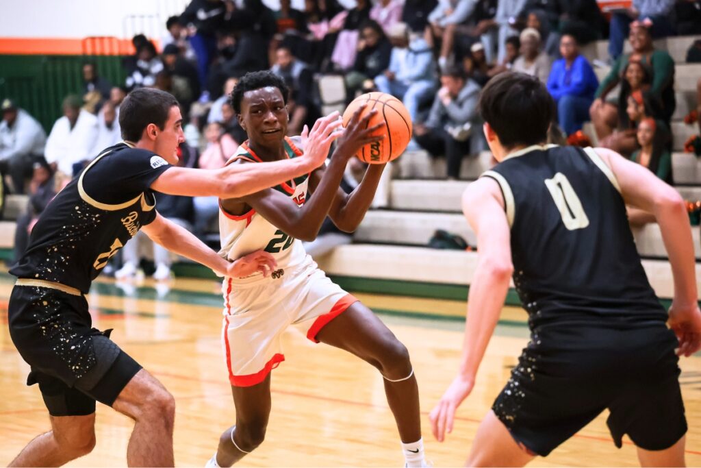 Eastside Kruise Crumedy (20) drives past Buchholz Gabe Williams (21) on Friday night. Photo by Chris Watkins