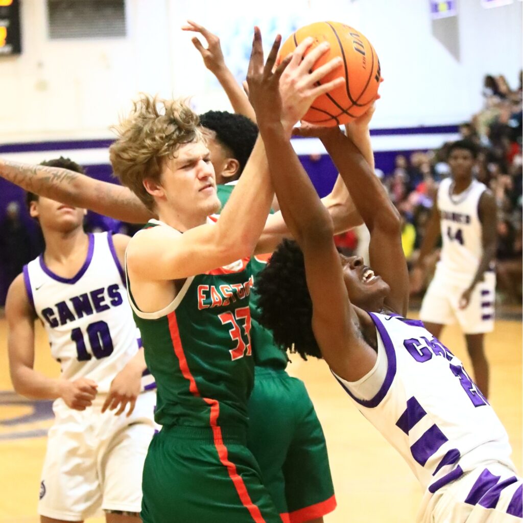 Eastside's Gage Webber (33) fights for a rebound against Gainesville's Anthony Jenkins Jr. (20). Photo by C.J. Gish