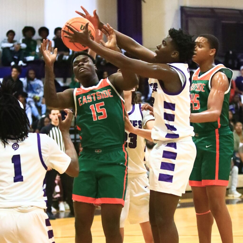 Eastside's Jordan Johnson (15) and Gainesville's Corvaughn White (3) go for a rebound. Photo by C.J. Gish