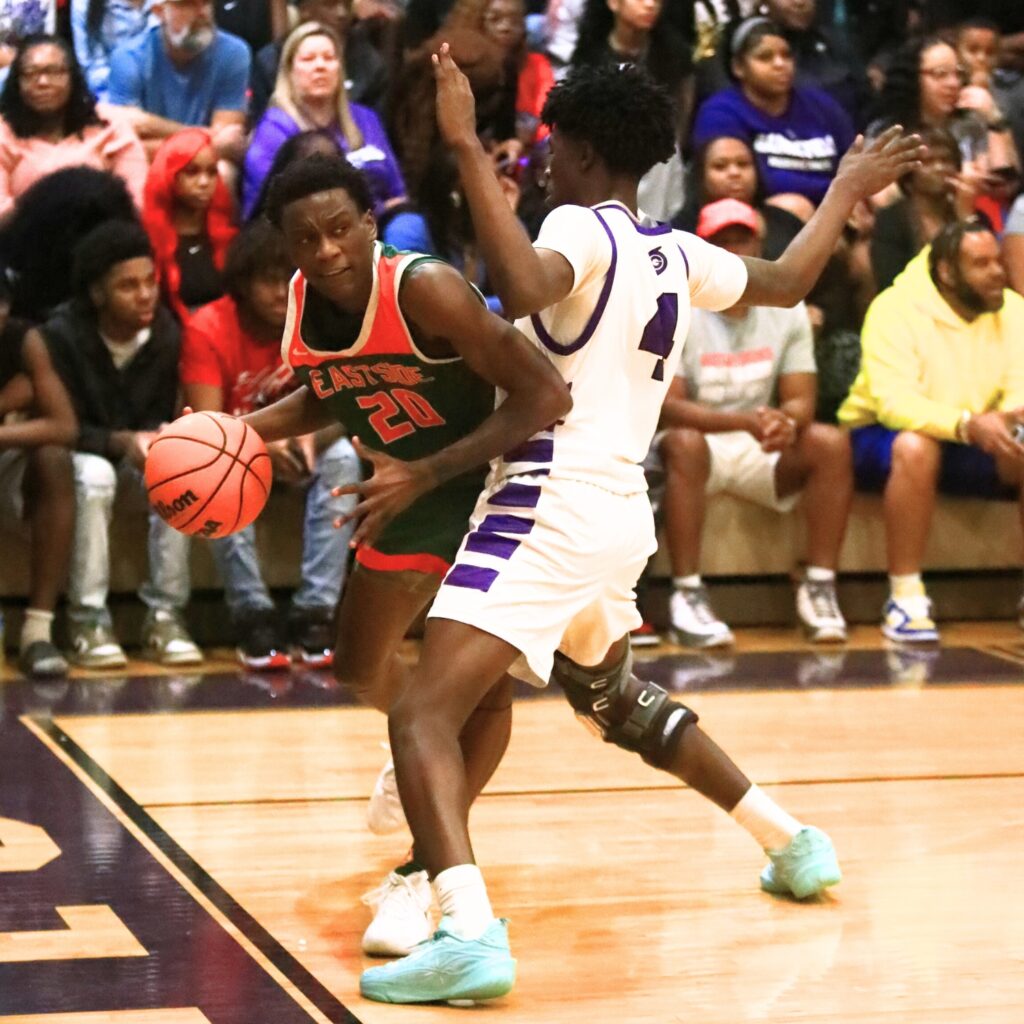 Eastside's Kruise Crumedy (20) tries to get around Gainesville's Craig Thomas Jr. (4). Photo by C.J. Gish