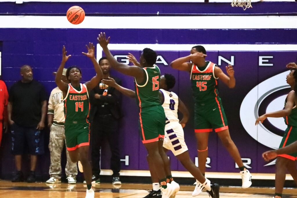 Eastside's LaQuon Prunty (14) and Jordan Johnson (15) go after a loose ball against Gainesville's Brandon Douglas (0). Photo by C.J. Gish