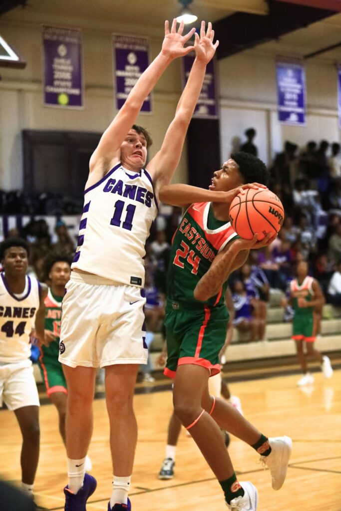 Eastside's Raheem Littles (24) puts up a shot against Gainesville's Kyle Pinter (11). Photo by C.J. Gish