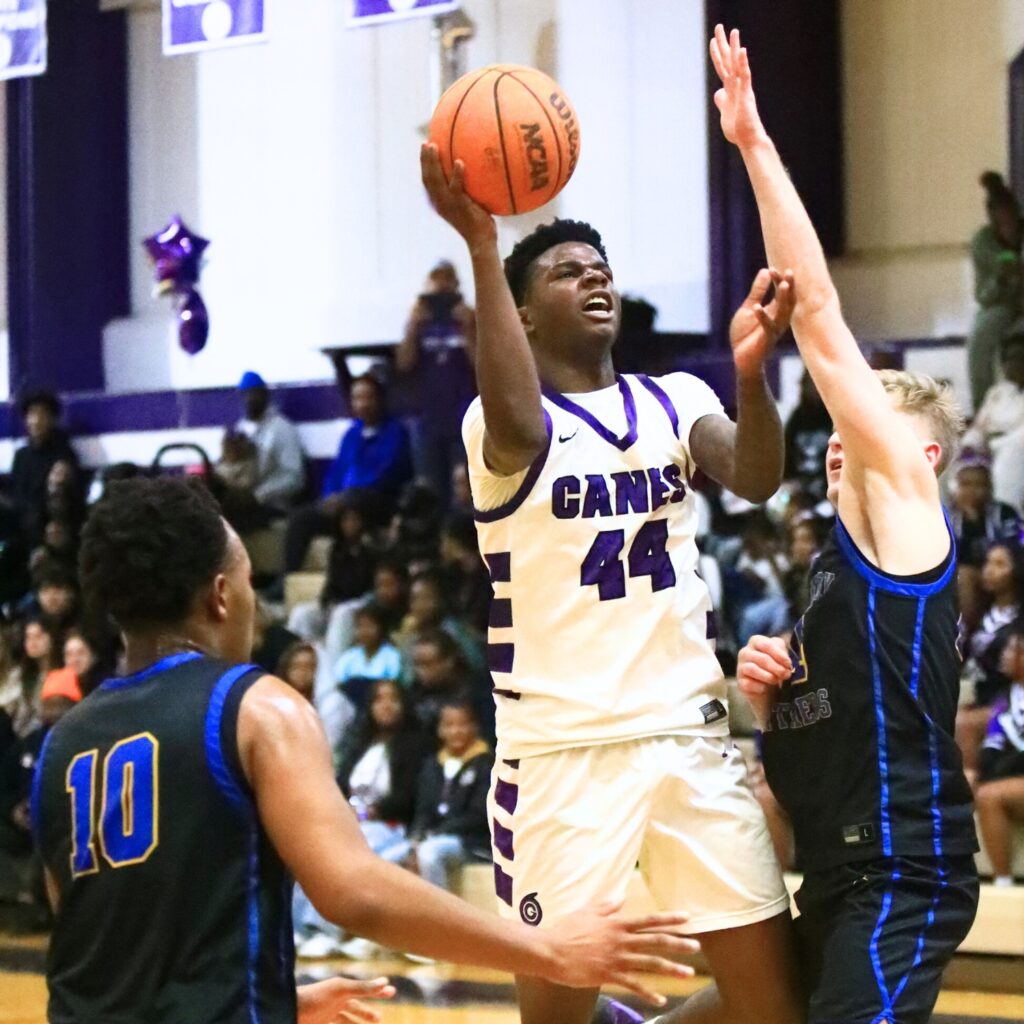 Gainesville's AJ Hall (44) puts up a shot against Newberry's Colton Sembower (14). Photo by C.J. Gish