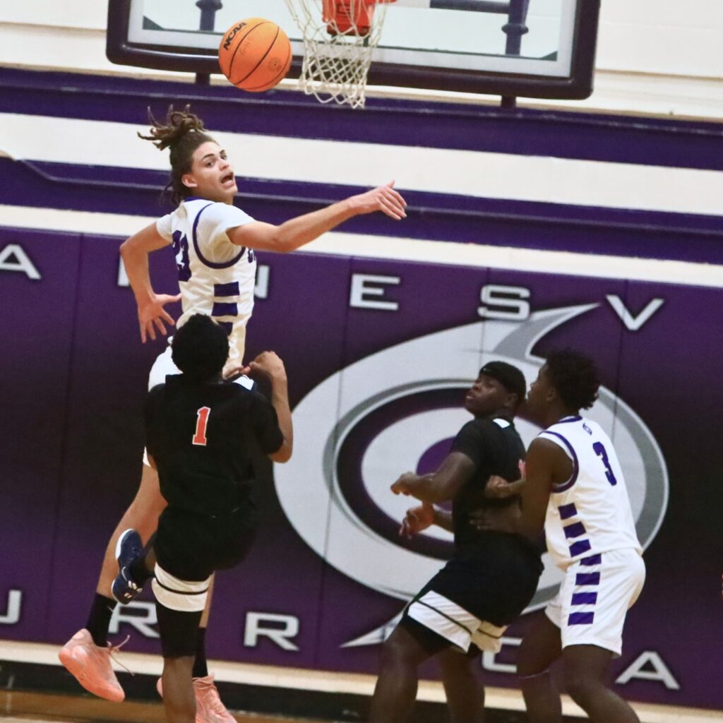 Gainesville's Aiden Raney (23) blocks a shot attempt by Shaun Bowie (0). Photo by C.J. Gish