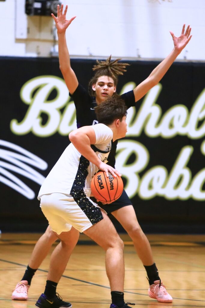 Gainesville's Aiden Raney (23) defends against Buchholz's Evan Walker (22). Photo by C.J. Gish