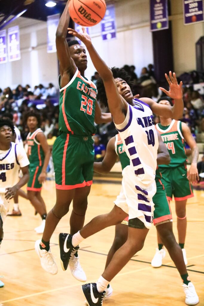 Gainesville's Anthony Jenkins Jr. (20) puts up a shot against Eastside's Kruise Crumedy (20). Photo by C.J. Gish