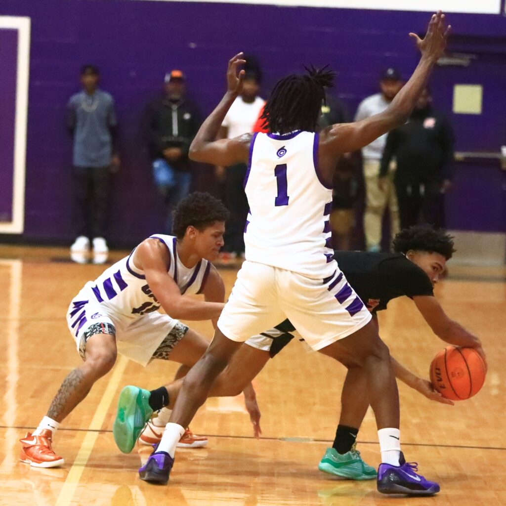 Gainesville's Bronx Johnson (10) and Willie Brooks (0) trap Hawthorne's Darian Bowie (0). Photo by C.J. Gish